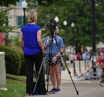 Reporter Providing Updates In Front Of Cameraperson In Huntsville, Alabama