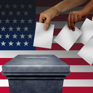 Illustration Of U.S. Voters Placing Ballot In Ballot Box With U.S. Flag in Background