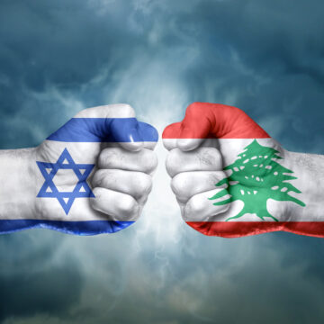 Flags Of Israel And Lebanon Painted On Two Clenched Fists