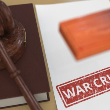 A War Crime Dossier On A Judge's Table With Gavel