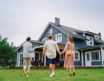 Real Estate Agent Showing A Big, Beautiful House To A Couple