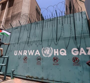 Palestinian Refugees Gather With National Flags Outside The UNRWA Headquarters