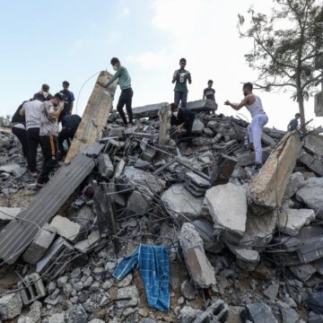 Palestinians Search A House Destroyed After An Israeli Air Strike