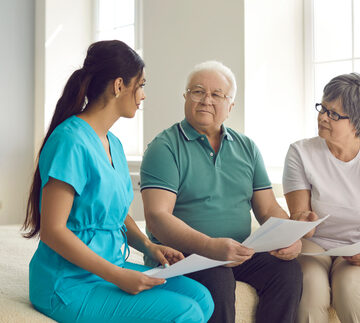 Caretaker Helps Senior Patients Sign Healthcare Paperwork