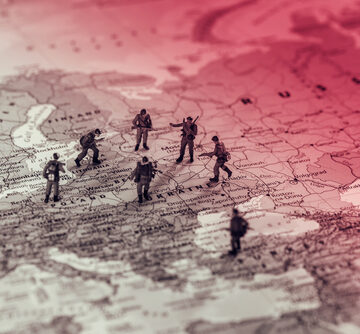Conceptual Image Of Toy Soldiers Standing On A Map Of Eastern Europe