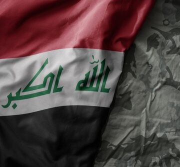 Iraqi Flag Draped Over Camo Material