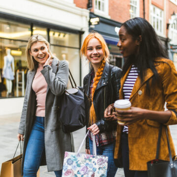 A Multiracial Group Of Young Women Shopping And Walking In London