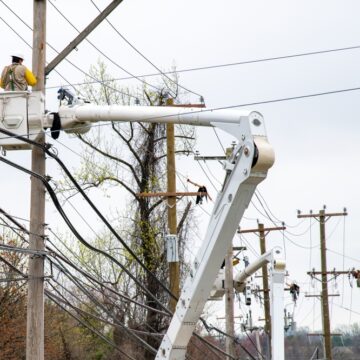 Electricians Working On Power Lines