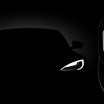 Black Electric Car At Night At A Charging Station