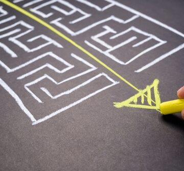 Hand Draws A Direct Line Through A Maze