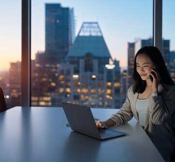 A Smiling Female Executive Working On Laptop