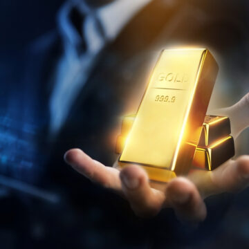 Hands Holding Bars Of Gold