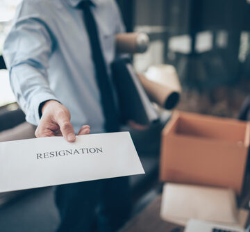 Businessman Handing Over Resignation Letter To Employer