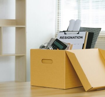 Concept Of Resignation Showing Letter Of Resignation And Cardboard Box With Personal Belongings