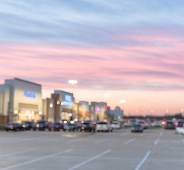Blurred Image Of The Exterior View Of Empty Parking Lots At A Mall