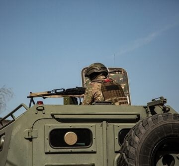 A Soldier In A Tank With A Machine Gun During Military Operations In Ukraine