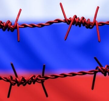 Barbed Wire With Background Of Flag Of Russia Symbolizing Sanctions