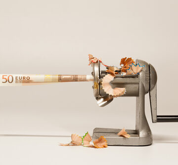 A Twisted Euro Note Going Into A Pencil Sharpener Symbolizing Inflation