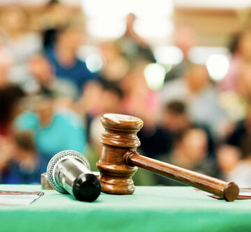 Gavels Used By Auctioneer And Audience Of Bidders In Background