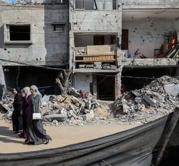 Palestinian Women Inspect Their Destroyed Homes After An Israeli Air Strike