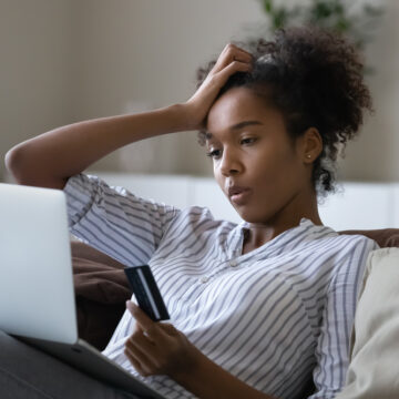 Unhappy Millennial African American Woman Distressed With Problems Paying Online