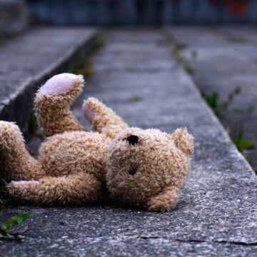Teddy Bear Laying On It's Side By The Curb