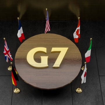 Round Table Surrounded With Countries' Flag And G7 Emblem on Table Top