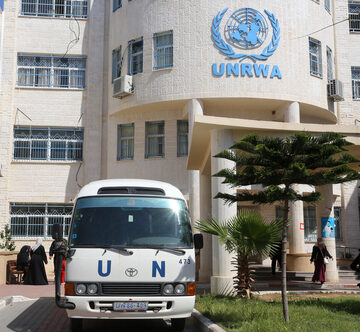 Employees, A Bus, And The Exterior Of The United Nations Relief And Works Agency