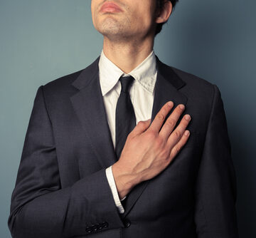 Young Businessman Swearing Allegiance With His Hand On His Heart