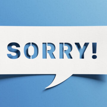 Stencil Of The Word Sorry On A Blue Background