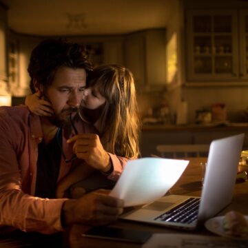 Daughter Comforting Distressed Father During Financial Crisis