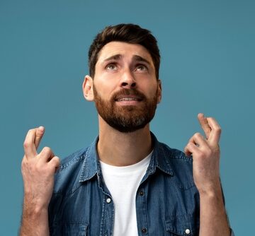 Funny,Hopeful,Man,With,Beard,Crossing,Fingers,For,Luck,,Making Hopeful Man With Beard Crossing Fingers For Luck