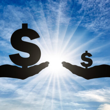 Silhouette Of Two Hands Holding Dollar Signs–One Large, One Smaller