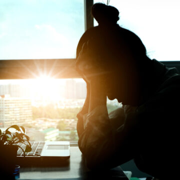 Woman,Sitting,Down,,His,Face,Unsettled.,At,The,Computer,Desk Woman, With Her Head In Her Hands, Sitting At The Computer