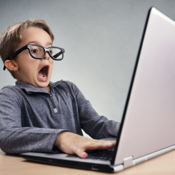 Shocked And Surprised Boy On The Internet With Laptop Computer