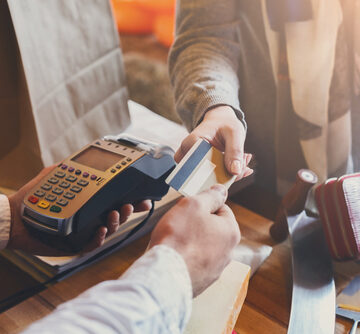Customer Paying For Purchase Using Credit Card Reader