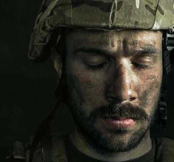 Close Up Portrait Of Young Male Battleworn Soldier