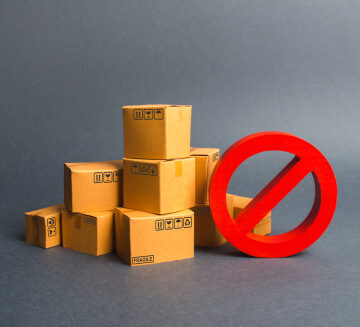 Cardboard Shipping Boxes And A Red Circle With A Line Through It