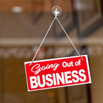 Red,Sign,Hanging,At,The,Glass,Door,Of,A,Shop Red Going Out Of Business Sign Hanging On A Glass Door Of A Shop