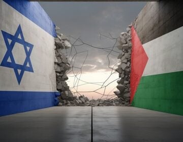 The Israeli And Palestinian Flags Separated By A Crumbled And Broken Stone Wall
