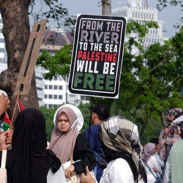 Palestinian Liberation Demonstrators Holding Signs With The Slogan "From The River To The Sea Palestine Will Be Free"