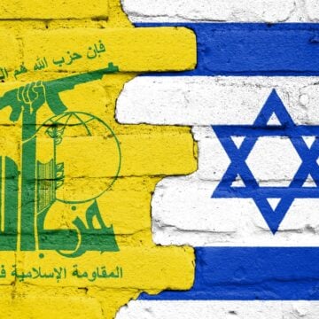Flags Of Hezbollah And Israel Painted On A Brick Wall