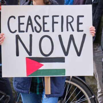 Protesters Holding "Ceasefire Now" Sign