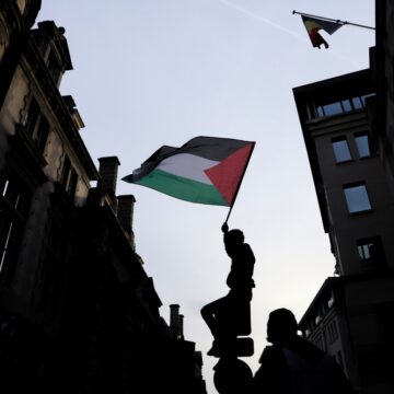 Person Waving Palestinian Flag During A Demonstration In Brussels