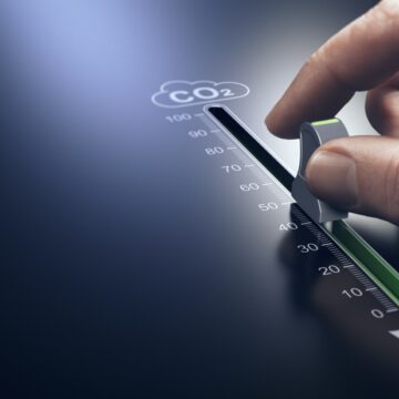 Hand Using A Slider To Reduce C02 Emissions