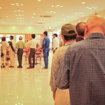 Long Line Of People Inside Building