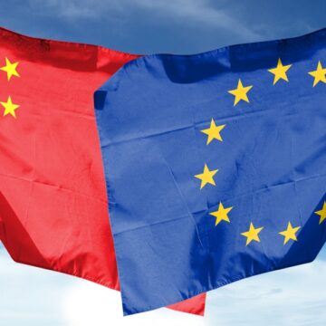 China Flag And EU Flag Waving On A Cloudy Day