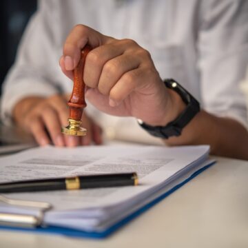 Businessman With Contract Or Paper Work Getting A Rubber Stamp