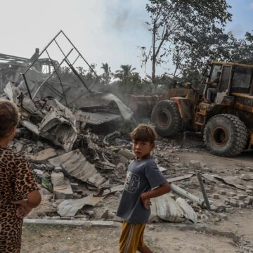 A Palestinian Family Inspects The Site Of An Israeli Airstrike