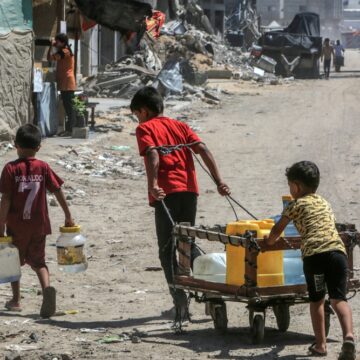 Palestinian Children Collect Drinking Water In the Palestinian City Of Khan Yunis